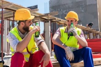 Tradies drinking beers on the job site after work