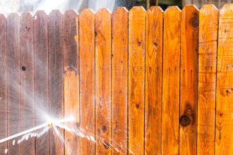 fence being cleaned with hose