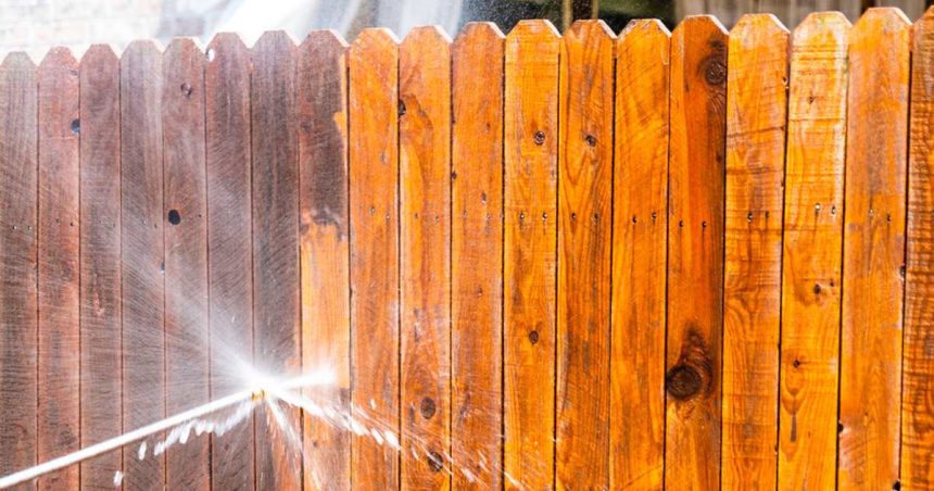 fence being cleaned with hose