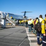 tradies lining up to board plane