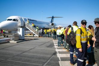 tradies lining up to board plane