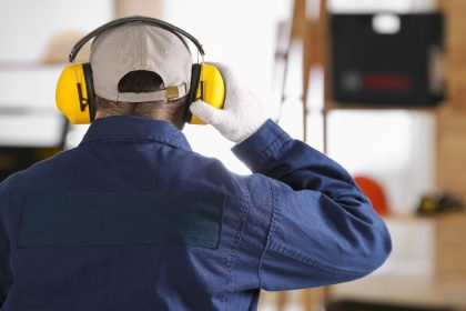 a tradie adjusts his hearing protection