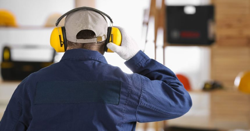 a tradie adjusts his hearing protection