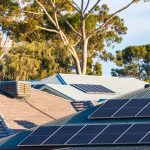 solar panels across several roofs in Australian suburbs