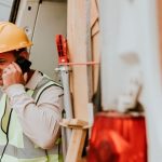 Tradie on phone call in back of work van