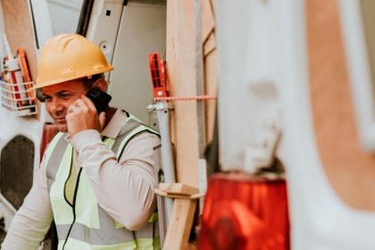 Tradie on phone call in back of work van