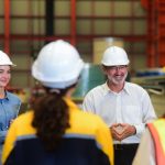 a tradie teaches a group of young new skilled workers