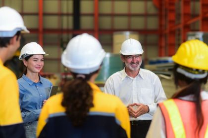 a tradie teaches a group of young new skilled workers