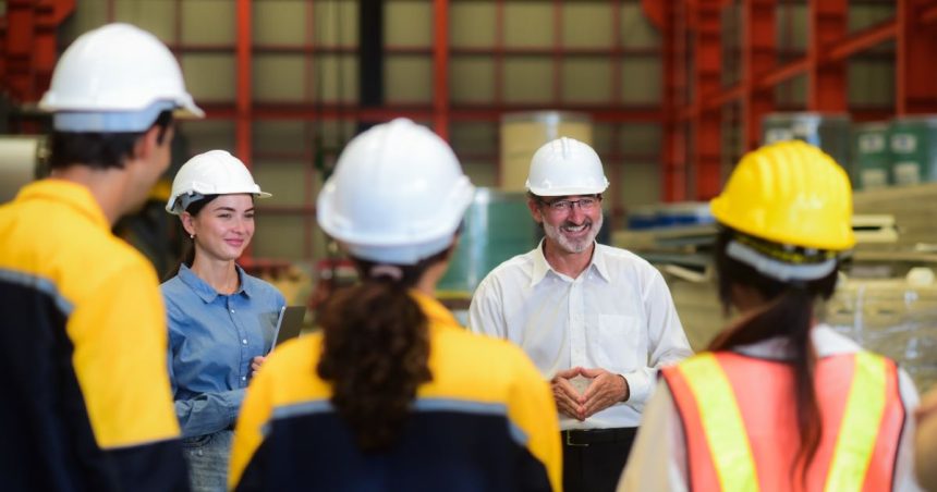 a tradie teaches a group of young new skilled workers