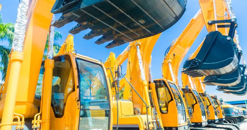 Second-hand construction equipment sitting in lot side-by-side