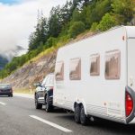 caravan being towed by car on highway