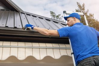 a man cleans his gutters