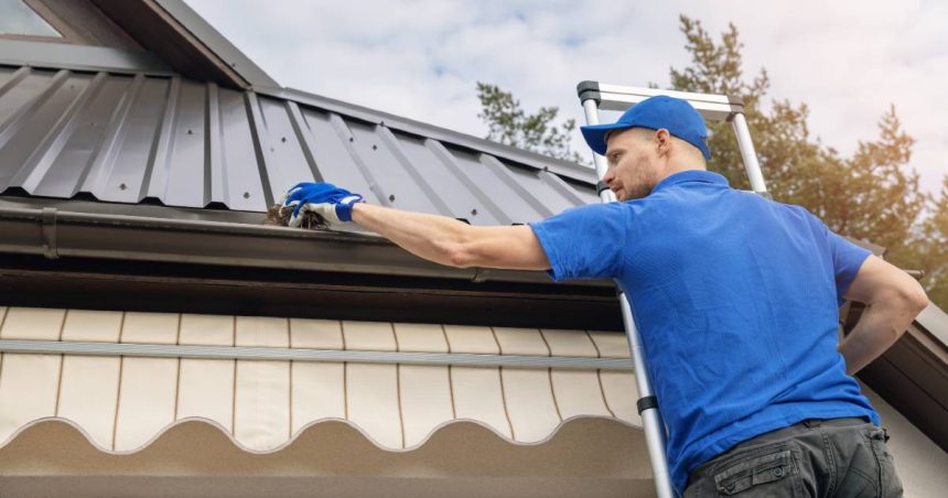 a man cleans his gutters